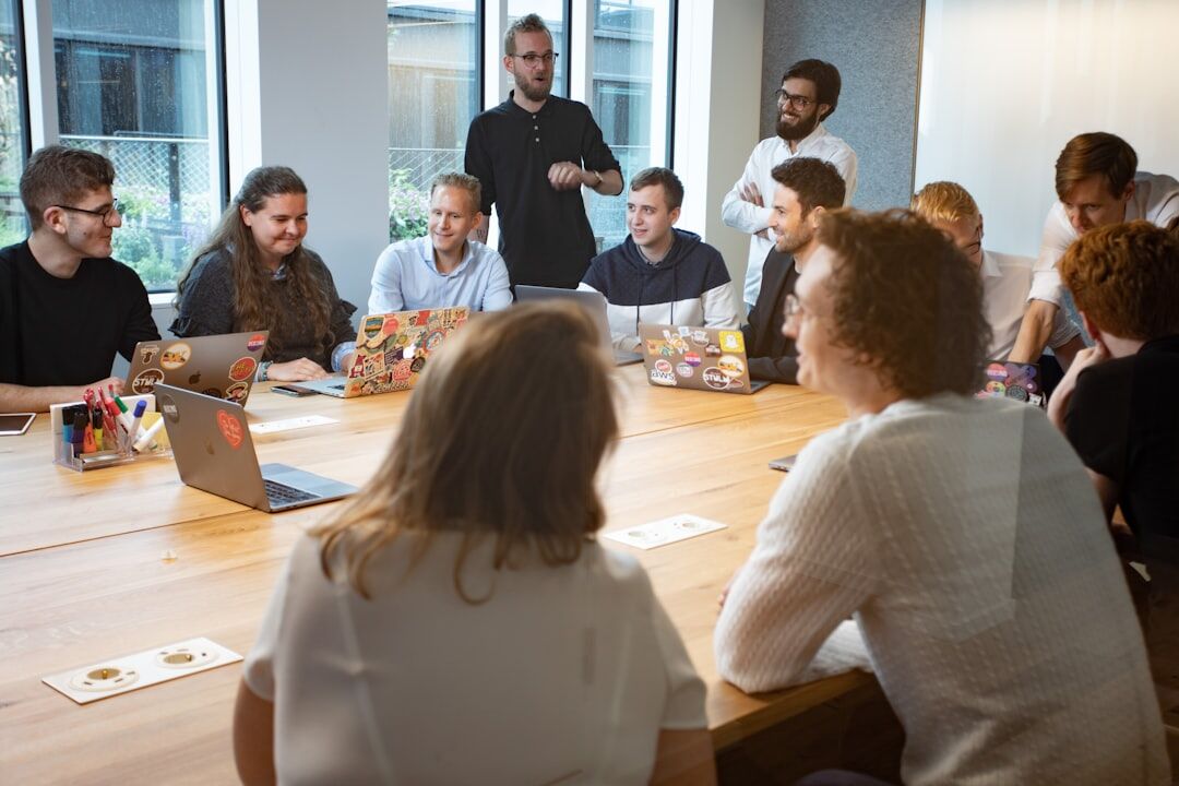 Diverse editorial team discussing content around a table
